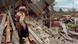 A woman looks at destroyed buildings in the aftermath of the Spitak earthquake in 1988. A woman looks at destroyed buildings in the aftermath of the Spitak earthquake in 1988.