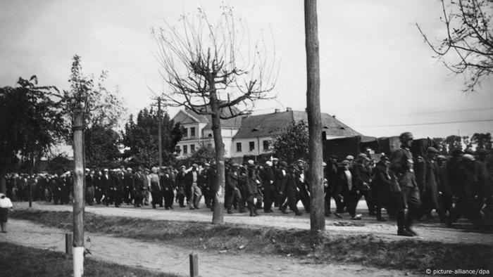 Nazi soldiers march a line of Yugoslavian prisoners of war through Belgrade in 1941