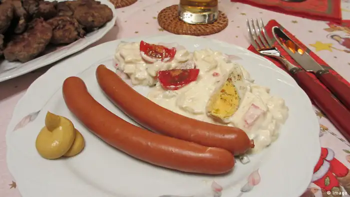 Kartoffelsalat und Würstchen liegen auf einem Teller (imago)