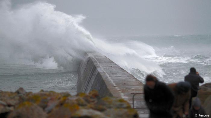Waves crash over the breakwater of Saint Evette harbour at Esquibien in Brittany as an Atlantic storm hits western France, December 23, 2013. Photo: Reuters