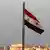 The Syrian flag flies above Damascus
