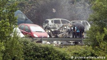 People observe the scene of a car bombing. (photo: EPA/ALFREDO ALDAI)