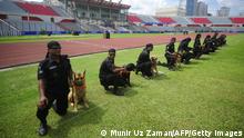 Members of the Bangladeshi Rapid Action Battalion (RAB) run through a security drill with sniffer dogs in the Bangabandhu National Stadium in Dhaka on September 4, 2011. Argentina and Nigeria, two of the powerhouses of international football, are expected to play an exhibition match at the stadium in Bangladesh on September 6, 2011. AFP PHOTO/Munir uz ZAMAN (Photo credit should read MUNIR UZ ZAMAN/AFP/Getty Images)