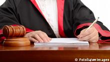 #51774637 - Female judge writing the verdict isolated on white background © uwimages