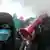 Виталий Кличко держит рупор и закрывает лицо от дыма