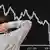 Маклер смотрит на кривую, отражающую падение биржевых котировок