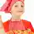 Young girl in a chef's outfit making pizza, with her thumb up Photo: Fotolia/Shmel