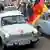 Trabant cars with an East German flag