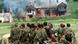 Jugoslavenski vojnici ispred zapaljenih kuća na Kosovu 1999. Jugoslavenski vojnici ispred zapaljenih kuća na Kosovu 1999.