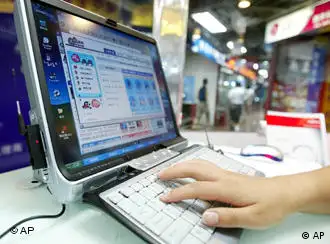 ** FILE ** A woman uses the internet at a computer store in Beijing in this July 21, 2004 file photo. Students in Beijing held protests after Chinese authorities barred non-students from using Shuimu.com, a Tsinghua University chat room which had become China's biggest university forum, on March 16, 2005. For 10 years, students, alumni and others used it for lively debates on everything from physics to politics. Now, due to the communist government's crackdown on subversive comments, the site is closed to users outside the university campus. (AP Photo/Greg Baker, File)