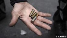 A man shows a bullet and empty casings during clashes with riot police near Independence Square in Kiev February 20, 2014. At least 21 civilians were killed in fresh fighting in Kiev on Thursday, shattering an overnight truce declared by Ukrainian President Viktor Yanukovich, and a presidential statement said dozens of police were also dead or wounded. REUTERS/Maks Levin (UKRAINE - Tags: POLITICS CIVIL UNREST)