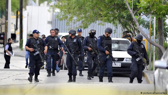 Heavily-armed policemen control the streets of Acapulco.