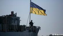 A member of the Ukrainian Navy stands guard on top of the Ukrainian navy command ship Slavutych at the Crimean port of Sevastopol March 5, 2014. REUTERS/Baz Ratner (UKRAINE - Tags: POLITICS CIVIL UNREST MILITARY)