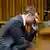 Oscar Pistorius holds his head in his hand during his trial in Pretoria. Photo: Reuters