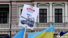 Ukraine's flags and a poster are pictured in front of Russia's embassy during a protest rally against Russian intervention in Crimea, in Riga March 2, 2014. Ukraine is preparing to defend itself against Russia but will ask other countries for help if Russia expands its military action, the Ukrainian ambassador to the United Nations said on Sunday. According to local media, about a thousand people attended the protest rally. REUTERS/Ints Kalnins (LATVIA - Tags: POLITICS CIVIL UNREST)