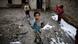 Afghan internally displaced children stand in a muddy yard at a poor neighborhood in Kabul Afghan internally displaced children stand in a muddy yard at a poor neighborhood in Kabul