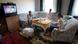 A Serbian family sits on a couch, watching TV A Serbian family sits on a couch, watching TV