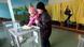 Referendum in Crimea, March 16, 2014. Woman holding a young child in her5 arm casts her vote in a ballot box Referendum in Crimea, March 16, 2014. Woman holding a young child in her5 arm casts her vote in a ballot box