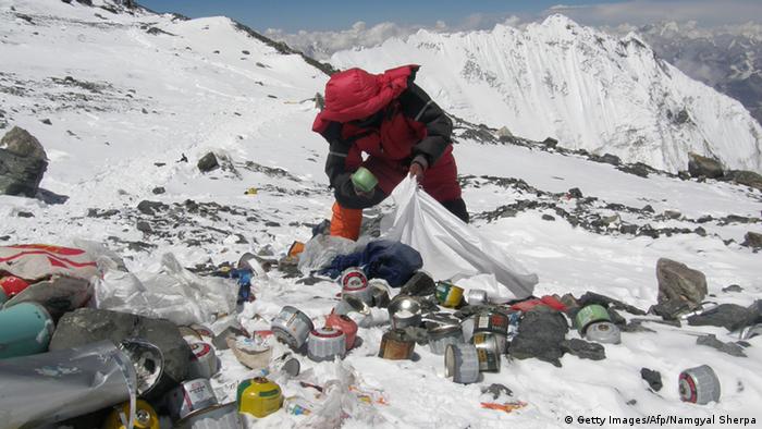 A Sherpa collects rubbish on Mount Everest