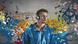 A young man listens to music against a colorful backdrop A young man listens to music against a colorful backdrop