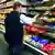 A supermarket employee stacking shelves