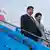 China's President Xi Jinping and his wife Peng Liyuan walk down the stairs from their aircraft prior to being greeted by Dutch King Willem Alexander and Queen Maxima at Schiphol Amsterdam airport, Netherlands, Saturday March 22, 2014.