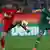 Leverkusen player Heung Min Son and Augsburg player Raul Bobadilla both put their left legs up to stop a ball