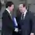 Hollande and Valls shake hands on April 2, 2014