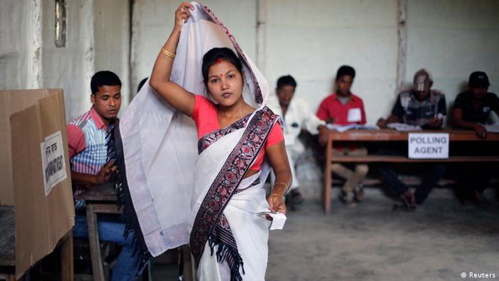 A woman adjusts her sari as she walks towards the polling booth to caste her vote at a polling station in Majuli, a large river island in the Brahmaputra river, Jorhat district, in the northeastern Indian state of Assam April 7, 2014. The first electors cast their votes in the world's biggest election on Monday with Hindu nationalist opposition candidate Narendra Modi seen holding a strong lead on promises of economic revival and jobs but likely to fall short of a majority