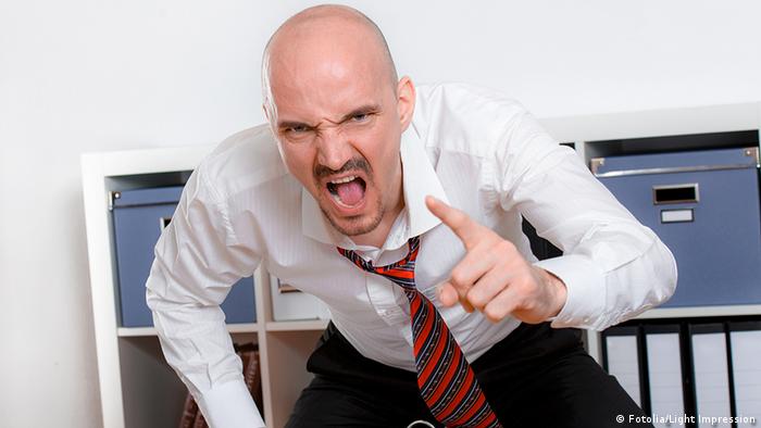 Stock image of an angry boss, shouting and pointing a finger