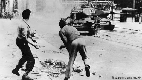 Lieutenant Tovolzhansky wipes his boots with Nazi flag at