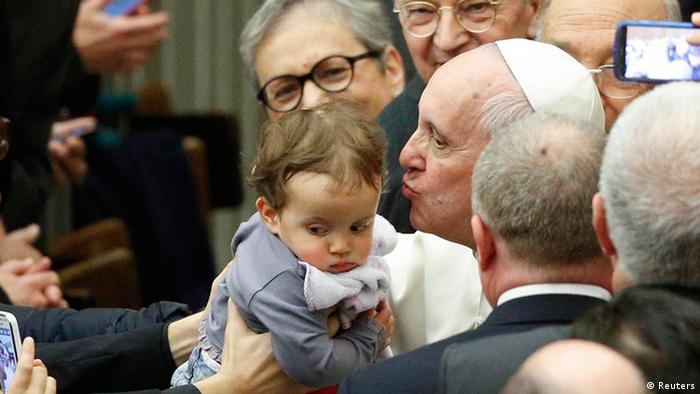 Der Papst küsst während einer Audienz im Vatikan ein Baby (Foto: Reuters)