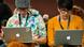 Two hipsters staring at their Apple laptops Two hipsters staring at their Apple laptops
