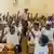 Children who have had malaria raise their hands in Burkina Faso schoolroom (Photo: Cécilia Conan)