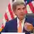 John Kerry with the US flag behind him