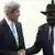 South Sudan President Salva Kirr and US Secretary of State John Kerry shake hands