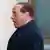 Former Italian Prime Minister Silvio Berlusconi looks on as he arrives to the Sacred Family Foundation, where he will serve part of his one-year tax fraud sentence by doing community service with the elderly, in Cesano Boscone, a small town on the outskirts of Milan May 9, 2014. The Milan court ruled that Berlusconi, one of Italy's richest men, must spend at least four hours a week in an old people's home. After completing the first six months, Berlusconi's one-year sentence will automatically be reduced to 10 and a half months. REUTERS/Stefano Rellandini