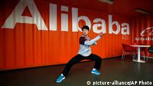 FILE - In this file photo taken Tuesday March 26, 2013, a worker performs shadow boxing during an open day at the Alibaba Group office in Hangzhou in east China's Zhejiang province. Alibaba Group is aiming to raise $1 billion in a long-awaited IPO likely to have ripple effects across the Internet. The Tuesday, May 6, 2014 filing sets the stage for the technology industry's biggest initial public offering since short messaging service Twitter and its early investors collected $1.8 billion in its stock market debut last fall. (AP Photo) CHINA OUT