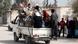 Moadamiya residents travelling on a truck in Syria Moadamiya residents travelling on a truck in Syria