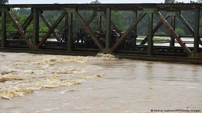 Rescue efforts on a bridge over a flooded river near the town of Lazarevac, 45 kilometers south of Belgrade.