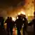Rioters in front of a burning building