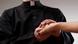 A symbolic picture of a priest holding a female's hand. A symbolic picture of a priest holding a female's hand.