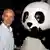Dr. Marco Lambertini standing next to the mascot of the WWF, a giant panda. (Photo: Andrew Goodman/Getty Images for Sony)