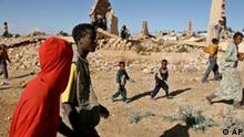 People walk past destroyed houses in what used to be the center of the city of Zalambessa, Ethiopia, on the border with Eritrea, in this file picture taken on Friday, Nov. 11, 2004. The city was almost entirely destroyed during the last war with Eritrea and most of its inhabitants still live in dire conditions in tents provided by the Red Cross or in destroyed houses. Ethiopia expressed concern Tuesday after the U.N. announced it was pulling peacekeepers out of almost half their border posts along the border that separates Ethiopian and Eritrean armies. (AP Photo/Boris Heger)