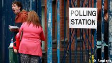 A man yawns outside a polling station in Beechmount Avenue during voting in the local council and European elections, in west Belfast May 22, 2014. REUTERS/Cathal McNaughton (NORTHERN IRELAND - Tags: POLITICS ELECTIONS)