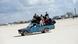 Syrian refugees in a car on the sand Syrian refugees in a car on the sand