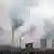 Smoke is discharged from chimneys and cooling towers at a coal-fired power plant in Shanghai, China, 2 February 2012