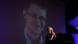 John Perry Barlow in einer Videokonferenz, im Hintergrund das Foto von Snowden (Foto: picture alliance/AP Photo) John Perry Barlow in einer Videokonferenz, im Hintergrund das Foto von Snowden (Foto: picture alliance/AP Photo)