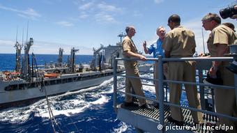 A picture made available 18 JULY 2012 Chief of Naval Operations (CNO) Adm. Jonathan Greenert, left, and Secretary of the Navy (SECNAV) the Honorable Ray Mabus observe as the Military Sealift Command fleet replenishment oiler USNS Henry J. Kaiser (T-AO 187), background, transfers biofuels to the guided-missile cruiser USS Princeton (CG 59) during a replenishment at sea.