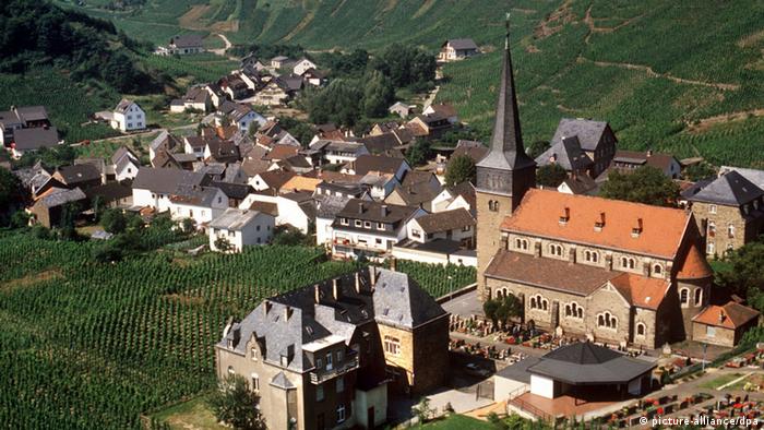The village of Mayschloss an der Ahr with a church and houses and vineyards